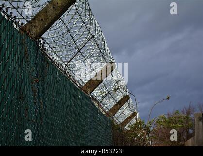 Razor wire atop a fence Stock Photo - Alamy