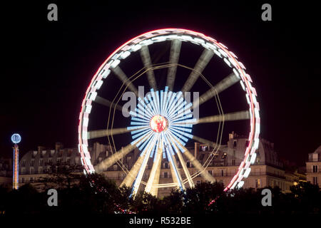 Spinning Ferris wheel in Paris at night Stock Photo