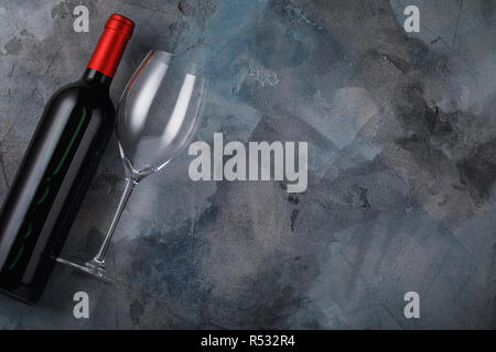 One empty glasses and bottle of red wine on table with copy space, top view Stock Photo