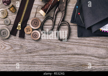 Tools for repairing clothes on wooden table with copy space, top view Stock Photo