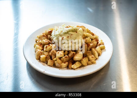 Yuca fried with hummus sauce. Stock Photo