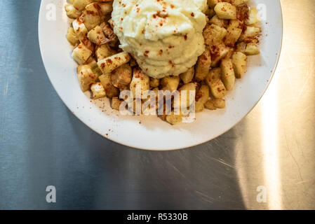 Yuca fried with hummus sauce. Stock Photo