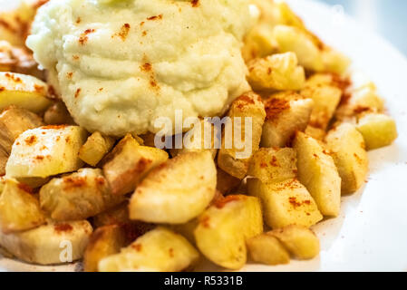 Yuca fried with hummus sauce. Stock Photo