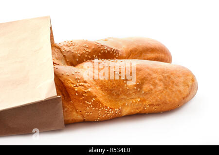 Fresh baguettes with sesame in paper bag isolated on white Stock Photo ...