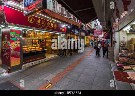 Tourists strolling in Rua do Cunha, the main street of Taipa village, with many shops and restaurants. Macau, January 2018 Stock Photo