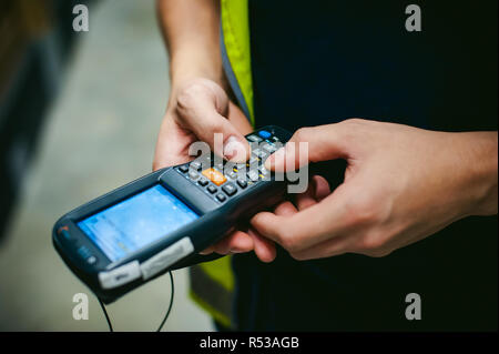 Worker Checking and Scanning Package by tablet handheld In Warehouse. Stock Photo