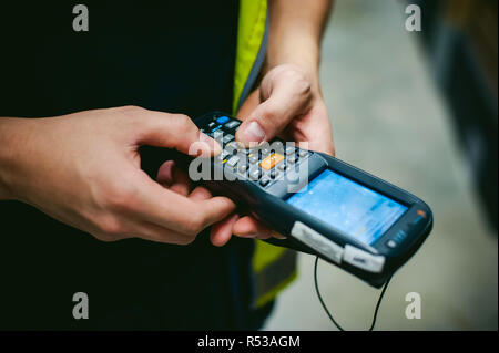 Worker Checking and Scanning Package by tablet handheld In Warehouse. Stock Photo
