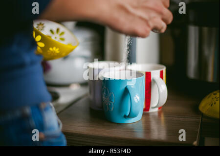 man making coffee. a married man with a ring on her finger, brew your morning coffee at breakfast for her family, three cups of coffee beverage Stock Photo