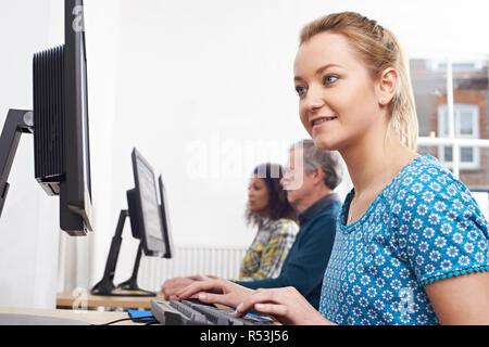 Young Woman Attending Computer Class In Front Of Screen Stock Photo