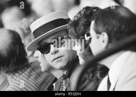 Live Aid dual venue benefit concert held on 13th July 1985 at Wembley Stadium in London, England, and the John F. Kennedy Stadium in Philadelphia, Pennsylvania, United States. The concerts were organised as a follow up to the Band Aid single 'Do They Know Its Christmas?'  to raise money for victims of the famine in Ethiopia. Picture shows  Elton John watching the concert at Wembley. Stock Photo