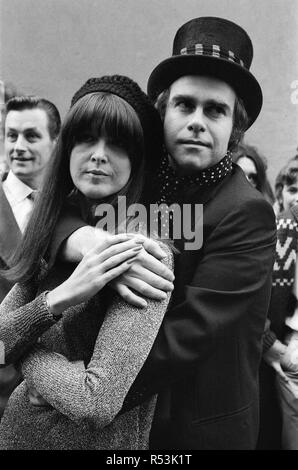 Wearing a top hat, Elton John, at a small studio in Ladbroke Grove to make a promotional film for his new single. Giving the film the feeling of the 1960's in the style of 'Ready Steady Go', Elton invited Cathy McGowan to take part. 5th October 1978. Stock Photo