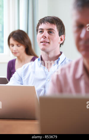 Young Man In Adult Education Class Stock Photo