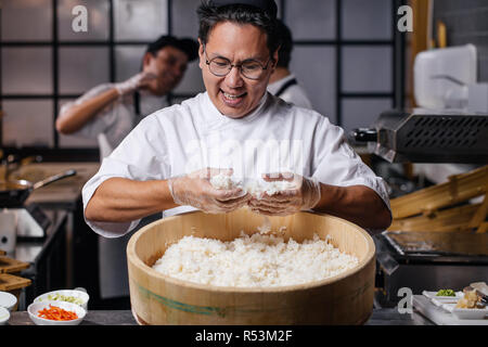 happy man holding the rice and checking it Stock Photo