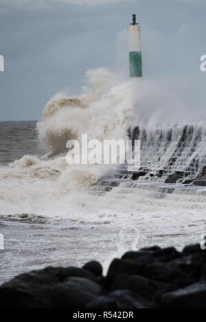 Aberystwyth Wales, UK. 29th Nov, 2018. UK Weather : For a second day Storm Diana, with strengthening winds gusting up to 70mph in exposed places, continues hammer huge waves against the sea defences in Aberystwyth on the Cardigan Bay coast of west Wales. The UK Met Office has issued another yellow warning for wind today for western part of the British Isles, with the risk of damage to property, some coastal flooding, and likely disruption to travel. photo Credit: keith morris/Alamy Live News Stock Photo