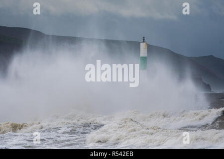 Aberystwyth Wales, UK. 29th Nov, 2018. UK Weather : For a second day Storm Diana, with strengthening winds gusting up to 70mph in exposed places, continues hammer huge waves against the sea defences in Aberystwyth on the Cardigan Bay coast of west Wales. The UK Met Office has issued another yellow warning for wind today for western part of the British Isles, with the risk of damage to property, some coastal flooding, and likely disruption to travel. photo Credit: keith morris/Alamy Live News Stock Photo