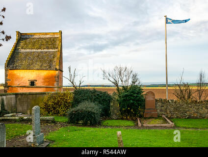 Athelstaneford, East Lothian, Scotland, United Kingdom, 29th November 2018.UK Weather:Birthplace of St Andrew's Cross, the saltire flag. On the eve of St Andrew's Day at the historic orange lime washed dovecot of the National Flag Heritage Centre. Legend says that on the eve of a battle between Picts and Angles from Northumbria in 832AD Saint Andrew had a vision of victory and when the Picts saw a white cross formed by clouds in a blue sky they attributed their victory to his blessing, adopting the cross as a flag Stock Photo