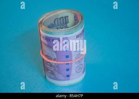 2000 and 100 rupee banknote India,The brand new Indian currency notes of 2000 and 100 rupees isolated on blue. Stock Photo