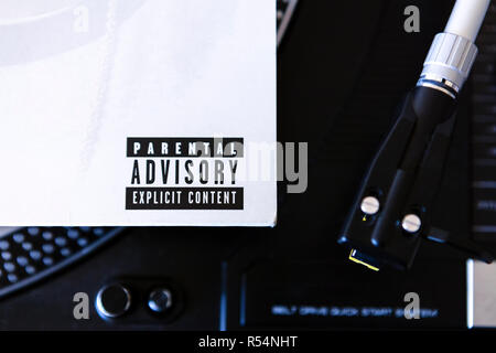 Close up of Parental Advisory lable on vinyl record sleeve on turntable Stock Photo