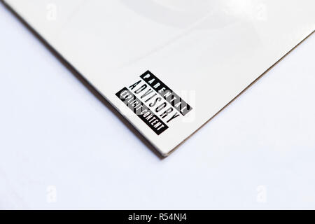 Close up of Parental Advisory lable on vinyl record sleeve on white background Stock Photo