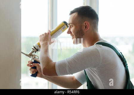 Worker is using a polyurethane foam for installation of window sill Stock  Photo - Alamy