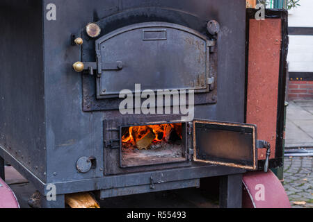romantic log fire with firewood Stock Photo