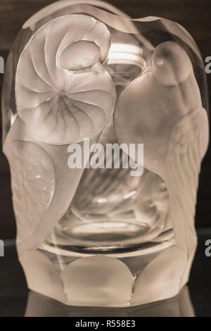 Close up of white hand cut lead crystal glass with two birds, germany Stock Photo