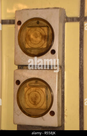 yellowed outdated dirty light switches, old and dirty light switches with plastic cover protected against moisture and wet Stock Photo