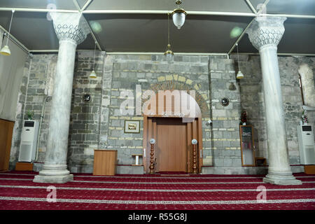 Trabzon, Turkey - September 6, 2018. Interior view of Aya Sofya mosque in Trabzon, Turkey, with two columns, furniture and Arabic inscriptions. Stock Photo