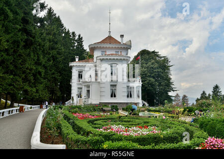 Trabzon, Turkey - September 8, 2018. Exterior view of Ataturk Mansion in Trabzon, with vegetation and people. Stock Photo