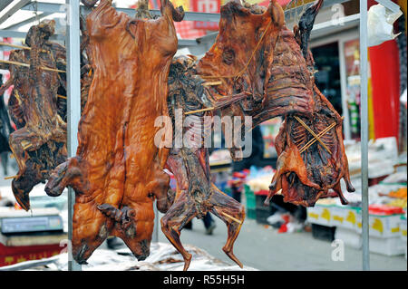 Butcher shop with various meats as Peking duck,chicken,pig in Beijing, China Stock Photo