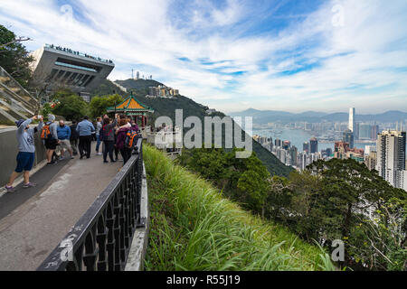 Tourists at Lion's Pavilion, near Victoria Peak, a scenic spot to enjoy the view of Hong Kong skyline. Hong Kong, January 2018 Stock Photo