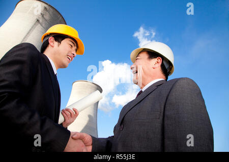 Businessmen at power plant Stock Photo