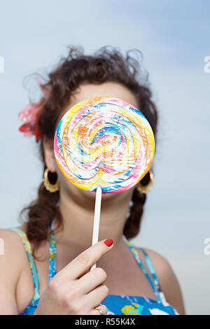 Woman holding a lollipop Stock Photo