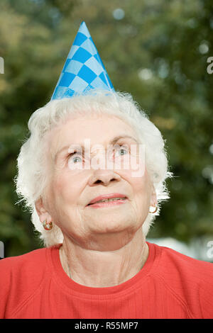 Senior woman at a birthday party Stock Photo