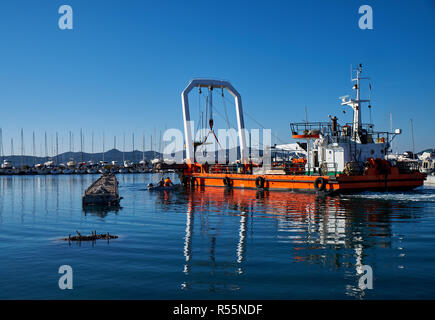 Zadar, Croatia.  Leverage crane on barge lifting part of concrete pier being demolished and replaced Stock Photo