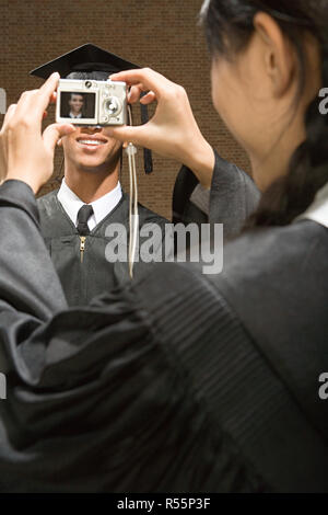 Graduates taking photographs Stock Photo