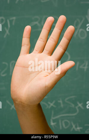 Student with hand raised Stock Photo