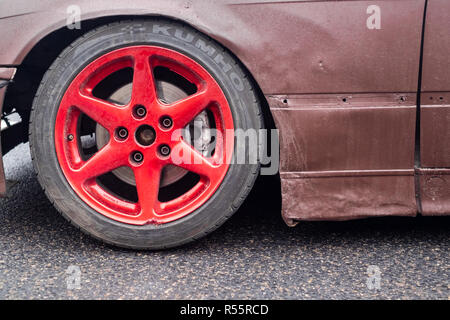 red amateur sports drift car wheel and rim close up Stock Photo