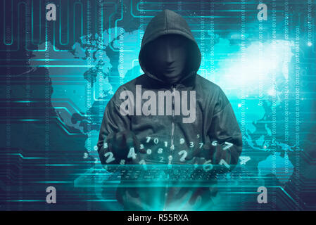 Hacker in mask typing keyboard hacking binary data Stock Photo