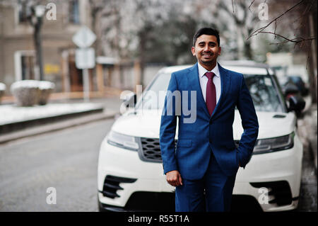 tuxedo man poses with hand on jacket and in pocket Stock Photo | Adobe Stock