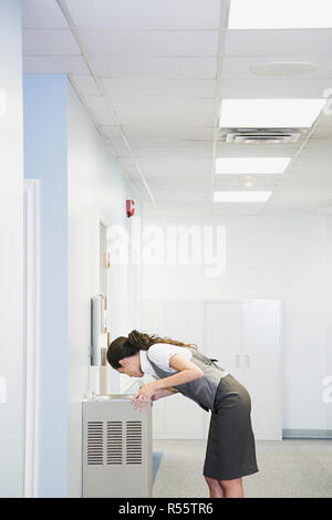 Office worker at water fountain Stock Photo