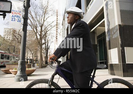 Businessman on bicycle Stock Photo