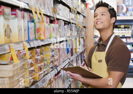 Sales assistant doing a stocktake Stock Photo