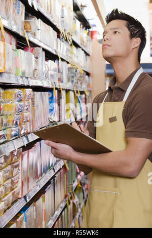 Sales assistant doing a stocktake Stock Photo