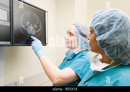 Surgeons looking at scan Stock Photo
