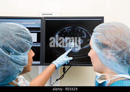 Surgeons looking at scan Stock Photo
