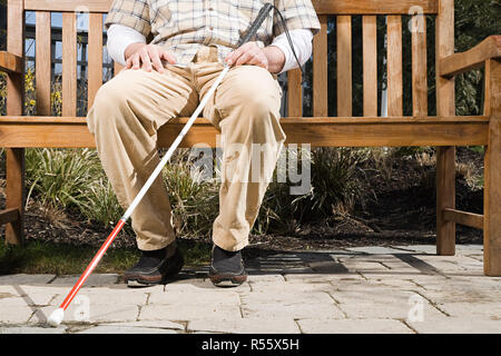 Blind man sitting on a bench Stock Photo