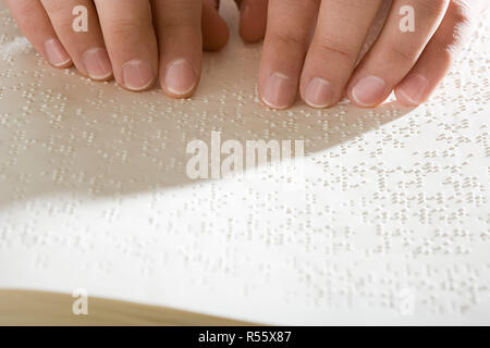 One woman reading braille Stock Photo
