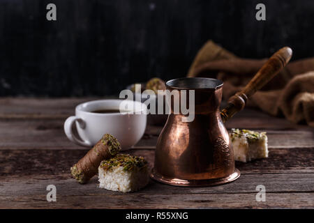 Traditional turkish coffee and turkish delight on dark wooden backgroundm copy space Stock Photo