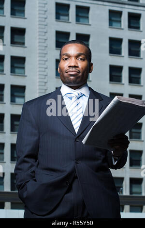 Businessman with newspaper Stock Photo